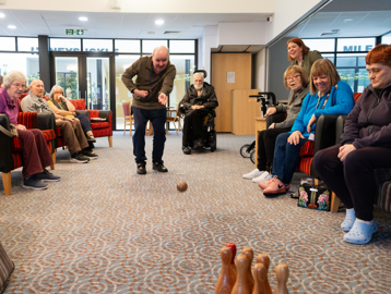 A group of residents playing skittles inside the function room