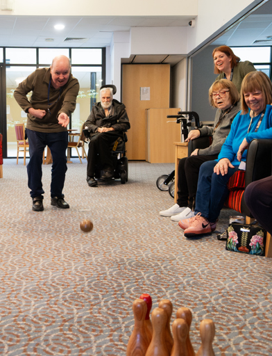 A group of residents playing skittles inside the function room 