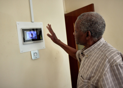 Resident on a video call using on wall tablet 