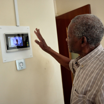 Resident on a video call using on wall tablet 