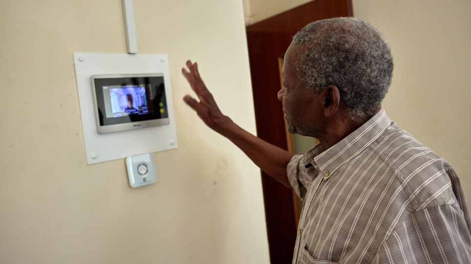 Resident on a video call using on wall tablet 