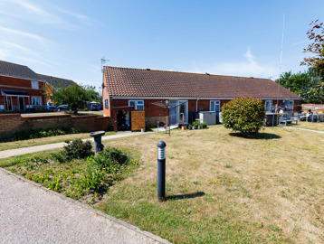 Attractive communal garden with flowerbeds, solar-powered lighting, hedges and decorative water features