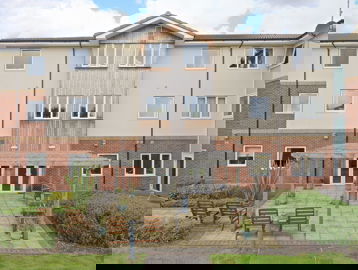 Communal garden area with chairs and benches at Alreywch Court