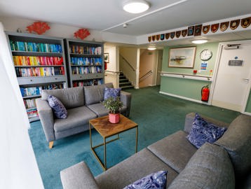 A communal space with two sofas and two large bookcases