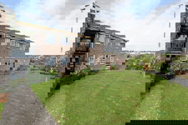 Large grassed area to the front of the scheme entrance