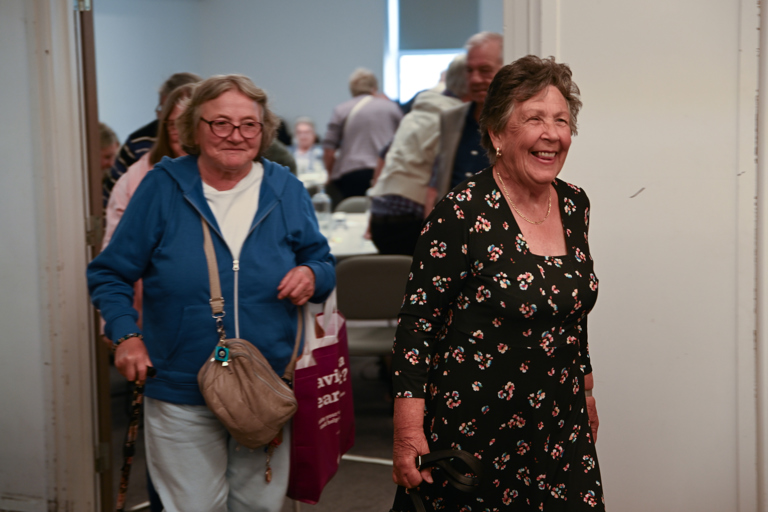 Smiling residents entering the venue