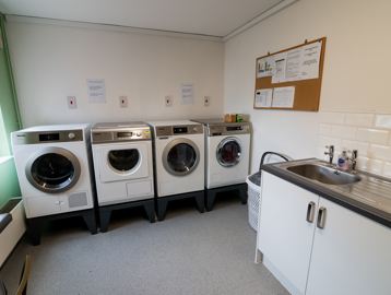 Communal laundry with washing machines and dryers