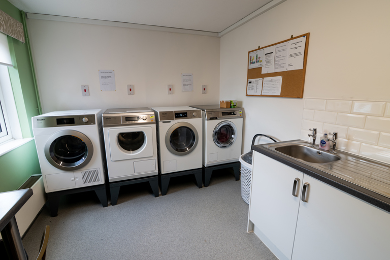 Communal laundry with washing machines and dryers