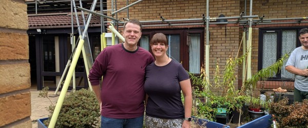 a man and woman smiling at the camera