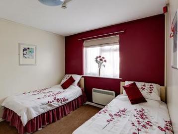 Two single beds in the bedroom of an apartment