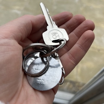 Caucasian hand holds a set of keys