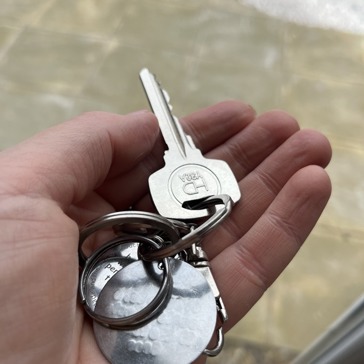 Caucasian hand holds a set of keys