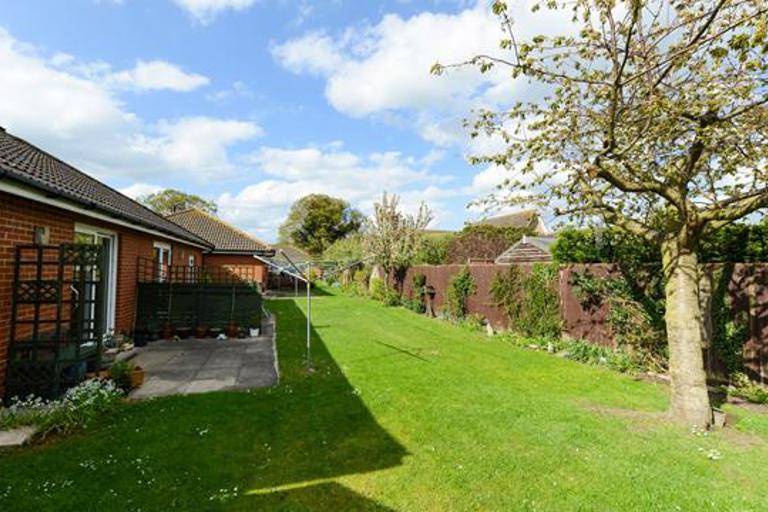 Gardens alongside bungalows with large trees