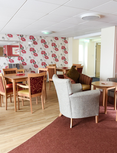 Communal lounge and dining area with soft seating and dining tables and chairs