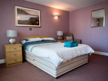 A double bed in the main bedroom of an apartment
