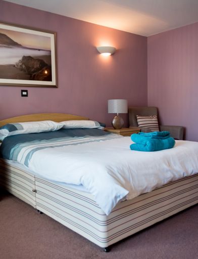 A double bed in the main bedroom of an apartment 