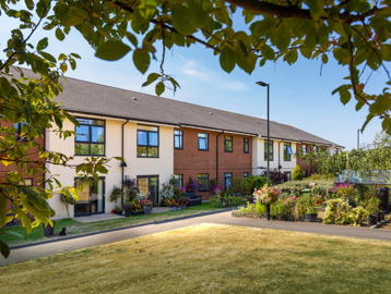 Outer building of Oakwood Gardens surrounded by greenery 