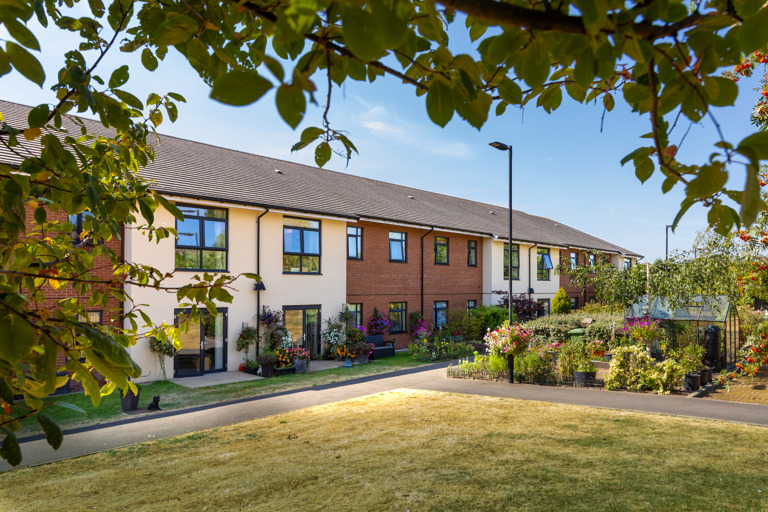 Outer building of Oakwood Gardens surrounded by greenery 