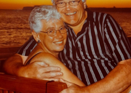 Resident Sue with arms around partner Dave. 