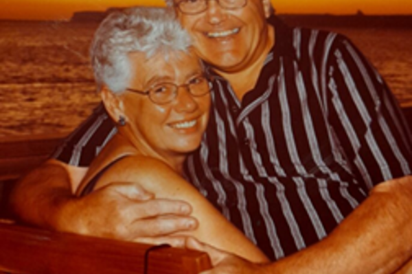 Resident Sue with arms around partner Dave. 