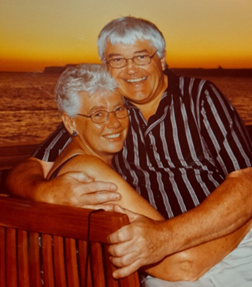 Resident Sue with arms around partner Dave.