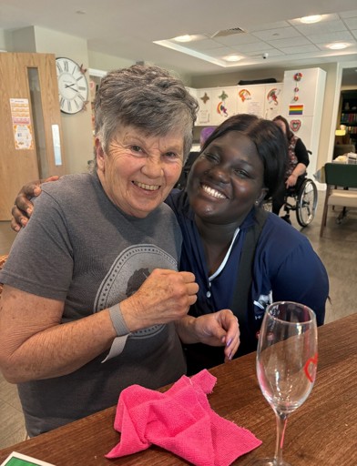 Resident Janet with a care worker 