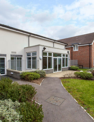 Communal garden with path, grassed area and shed at Alice Bye Court 