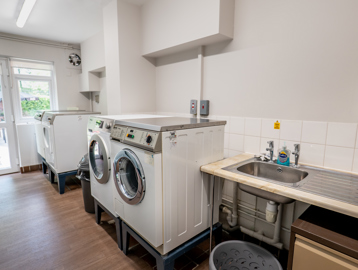 William Griffiths Court internal shot: A communal laundry room with washers and dryers