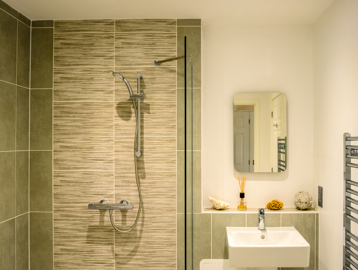 Show home bathroom with modern fixtures and walk-in shower