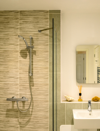 Show home bathroom with modern fixtures and walk-in shower 