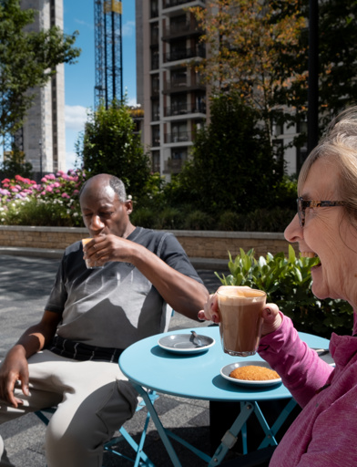 Minterne Apartments' residents pictured having a coffee and chat outside their local cafe sitting outside 