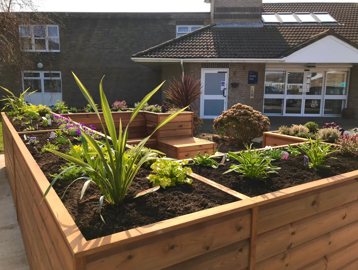 Close-up of the large planter and seating area outside of Ancaster Court