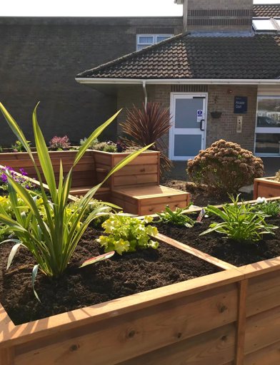 Close-up of the large planter and seating area outside of Ancaster Court