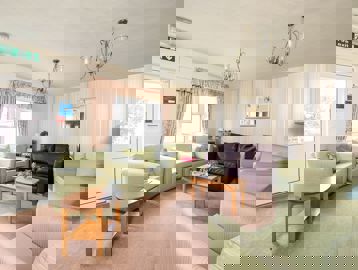 Residents' lounge with soft seating and tables