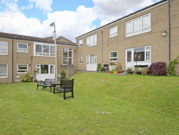 Communal rear gardens with large grassed area and benches