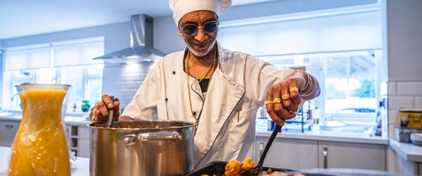 Resident smiling serving food
