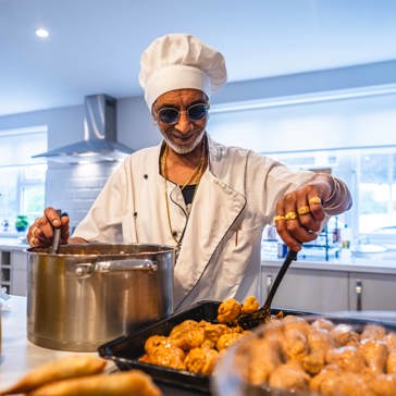 Resident smiling serving food