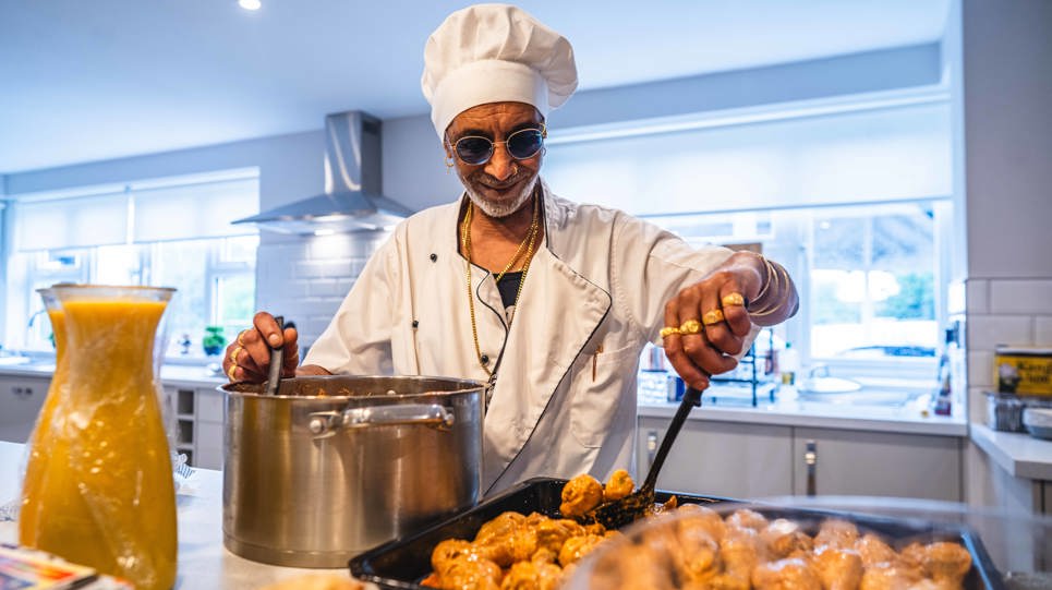 Resident smiling serving food