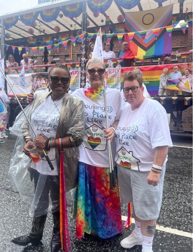 Colleagues stand next to Pride lorry 