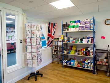 Inside of the communal shop with cards and household items on display
