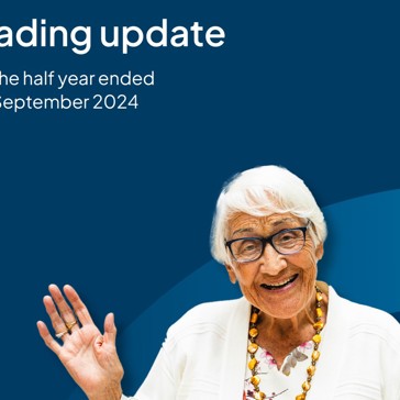 The front cover of the Trading Update with a resident waving 