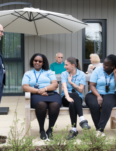 Colleagues outside Fern Meadows on a bench 
