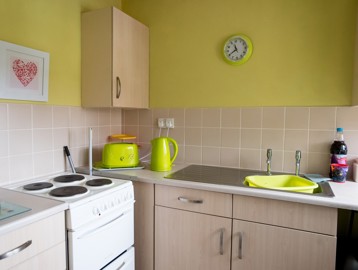 Bright green coloured kitchen inside a resident's apartment