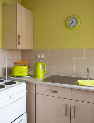 Bright green coloured kitchen inside a resident's apartment