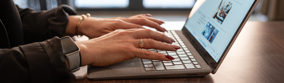Typing on a laptop 