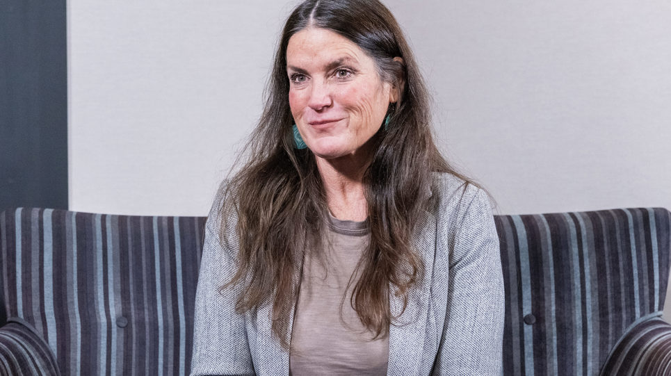 A Housing 21 employee smiling whilst sitting in a chair