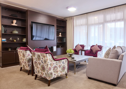the scheme communal area with a tv and chairs