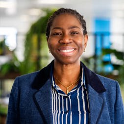 Housing 21 Board Member, Dr Bola Owolabi, smiles into the camera