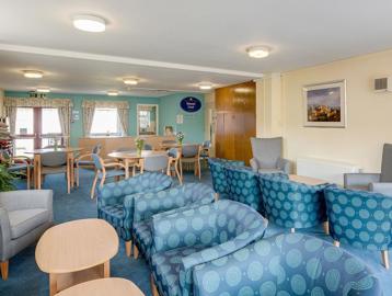 Communal lounge area with soft seating and coffee tables
