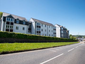 View of the side of the building from the roadside on a sunny day